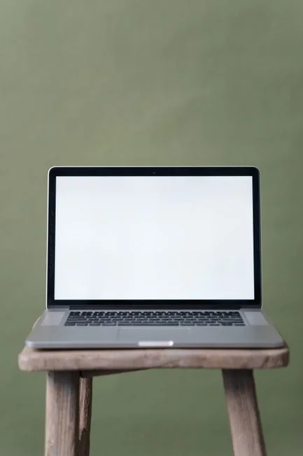 Modern tablet and smartphone displaying web content on a reflective surface, highlighting technology and connectivity.
